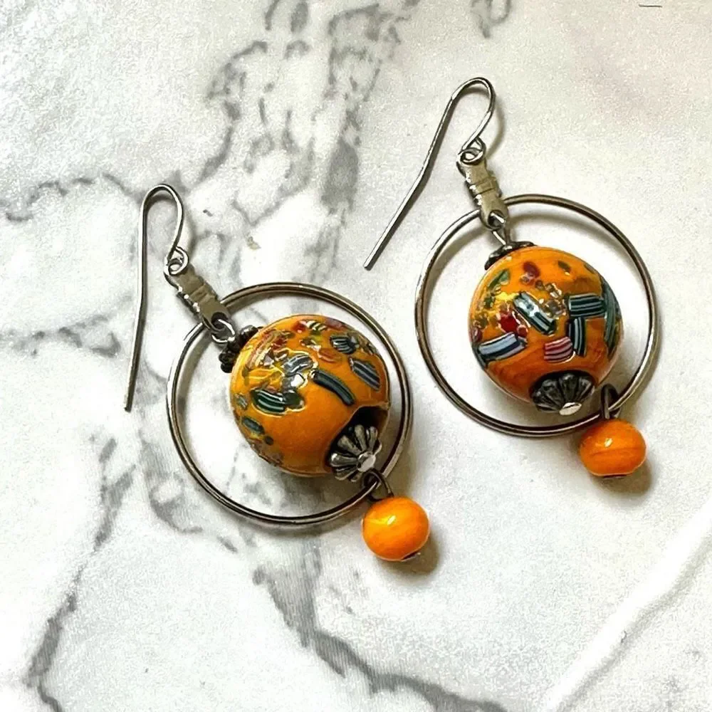 Silver tone orange beaded drop earrings